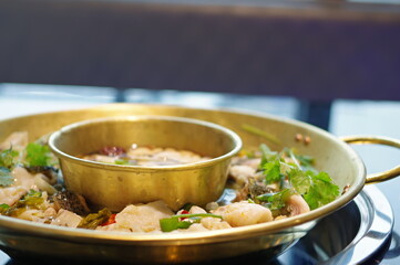 Spicy Sichuan hot pot with fish and coriander