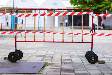 the white and red fence wheel used for situation of covid-19 in the university place.