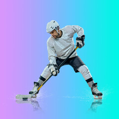 Naklejka premium Professional ice hockey player hitting puck for winning goal in action on gradient multicolored neon background. Concept of sport competition.