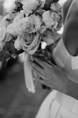 Bride holding beautiful colorful wedding bouquet.