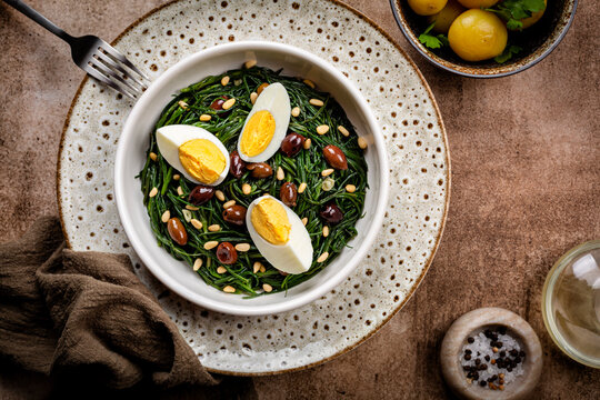 Spring Italian Salad. Sauteed Agretti with Taggiasca olives, pinoli or pine nut, and boiled eggs.