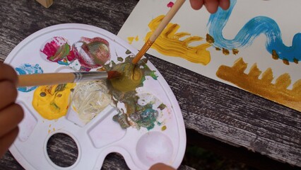 Identifying artistically gifted students. Acrylic paint on a palette, close up. Painting and art...