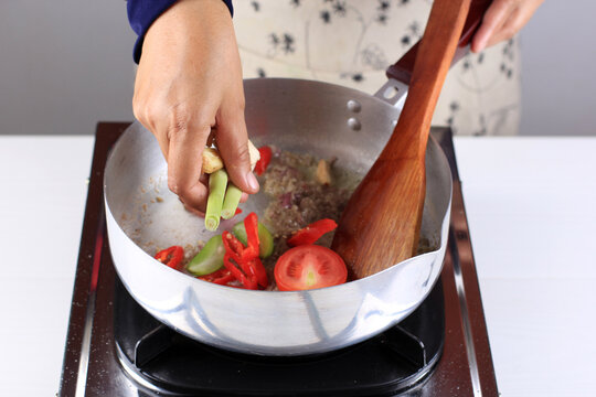 Female Hand Add Lemongrass To The Pan, Cooking Backstage Making South Asian Menu, Like Pindang Bandeng Or Fish Soup. Preparing Spice For Delicious Recipe