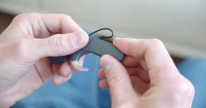 hands assemble hearing aid, cochlear implant, close-up