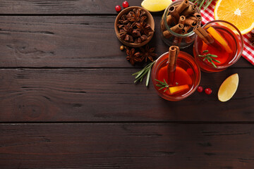 Aromatic punch drink and ingredients on wooden table, flat lay. Space for text