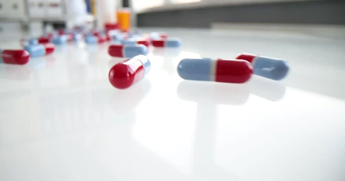 Medical capsule pills scattered on table closeup
