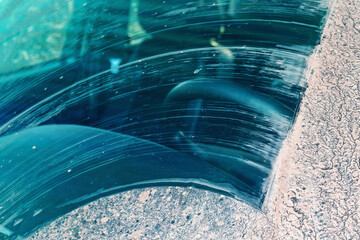 Heavily dirty crossover windscreen cleaned by a windscreen wiper after driving on a muddy dirt road