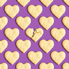 Seamless pattern with butter cookies in the form of heart on purple background.