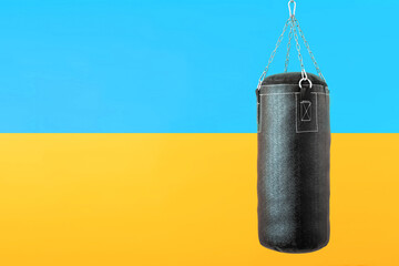 punching bag hanging on colorful flag of Ukraine