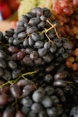 bunches of grapes lie on the market stalls