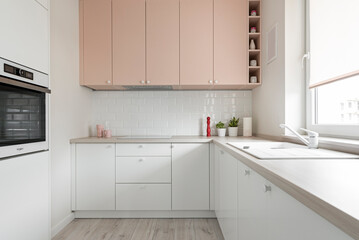 Kuchnia w minimalistycznym nowoczesnym stylu. Białe i różowe fronty mebli oraz sprzęt.  - obrazy, fototapety, plakaty