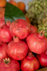 a lot of red pomegranate lies on the market