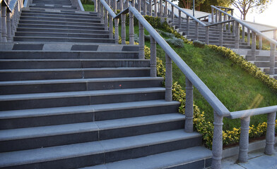 Architectural design of stair. Stone paved stairs in park. Granite, stone grey stairs. Wide staircase. Concrete stairs. Steps.