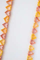 background, carbohydrate, closeup, concept, cooking, Pasta hearts shaped . Top view on white background. Diet, love and foot concept . Copy space. Dried pasta in heart shape.