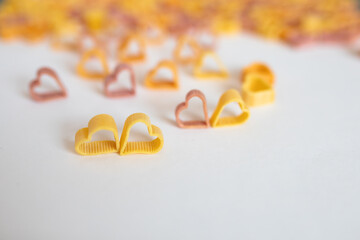 background, carbohydrate, closeup, concept, cooking, Pasta hearts shaped . Top view on white background. Diet, love and foot concept . Copy space. Dried pasta in heart shape.