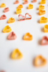 background, carbohydrate, closeup, concept, cooking, Pasta hearts shaped . Top view on white background. Diet, love and foot concept . Copy space. Dried pasta in heart shape.