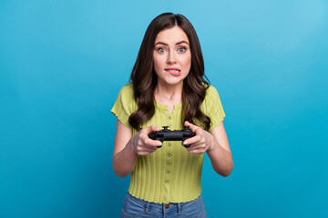 Photo of sad young brunette lady playstation bite lip wear green t-shirt isolated on blue background