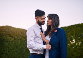 Whats his is hers from now on. Cropped shot of an affectionate young bride smiling at her groom while wearing his jacket on their wedding day.