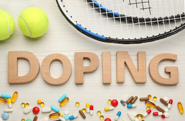 Flat lay composition with word Doping, tennis balls and drugs on white wooden table