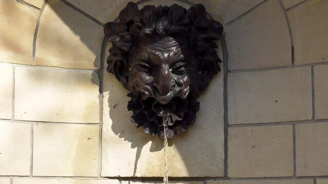 Water flowing out from Rodin's Mascaron in public Departemental Parc de Sceaux (Auguste Rodin - 1840-1917) - Hauts-de-Seine, France.