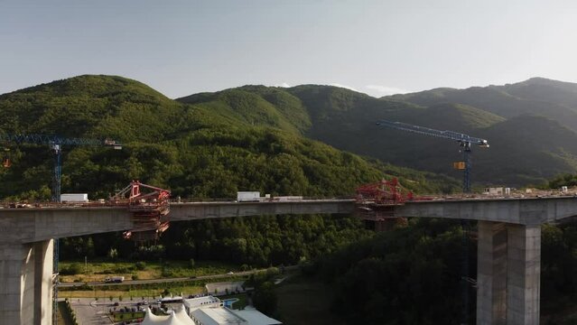 Highway bridge under construction. Aerial view of nes road. Freeway being built on a mountain terrain..
