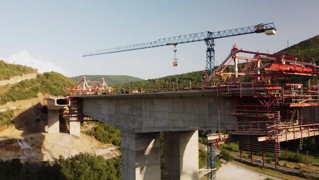 Highway bridge under construction. Aerial view of nes road. Freeway being built on a mountain terrain..
