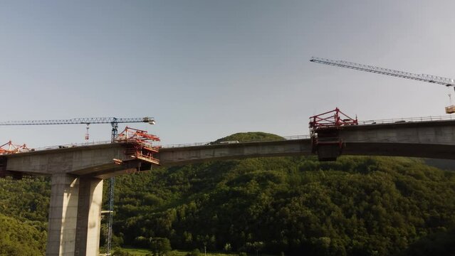 Highway bridge under construction. Aerial view of nes road. Freeway being built on a mountain terrain..
