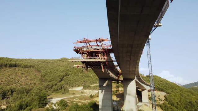 Highway bridge under construction. Aerial view of nes road. Freeway being built on a mountain terrain..