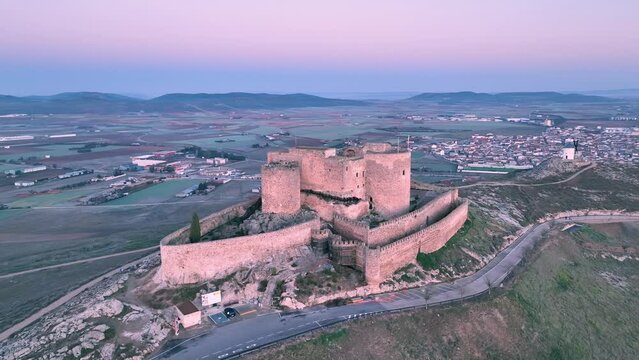 Castle of La Muela in Consuegra, Spain. Drone shot orbiting medieval fort