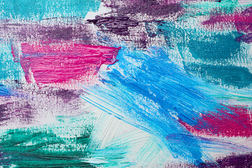 Strokes of colorful acrylic paints on white canvas, closeup