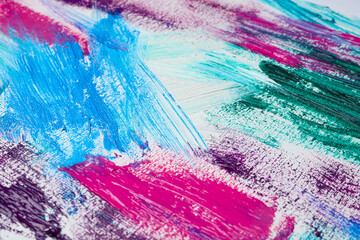 Fototapeta na wymiar Strokes of colorful acrylic paints on white canvas, closeup