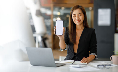Mockup image of a Young Asia lady show empty smartphone screen with with blank white screen...