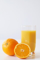 Fototapeta na wymiar Fresh oranges and freshly made orange juice are a boost of energy, vitamin C, and a good start to the day for vegetarians, raw foodists, and all food lovers.