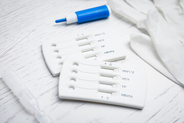 Disposable express test kit for hepatitis on white wooden table