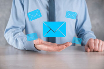 Businessman hand holding e-mail icon, Contact us by newsletter email and protect your personal...