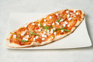 oval Pizza with Mozzarella cheese, Tomatoes, pepper, Spices and Fresh Basil. Italian pizza. Pizza Margherita or Margarita