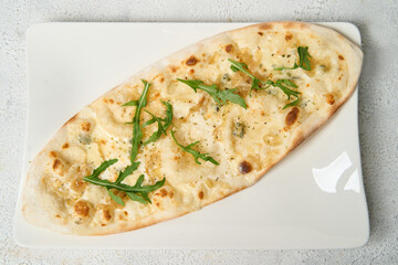 flatbread Pizza with Mozzarella cheese, Tomatoes, pepper, Spices and Fresh Basil. Italian pizza. Pizza Margherita or Margarita