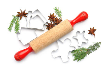Cookie cutters, rolling pin, fir branches and anise stars on white background, top view