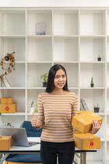 small business startup SME business owners entrepreneur using laptop Receive and check online orders to prepare packing boxes. Selling to customers. Online SME business idea.