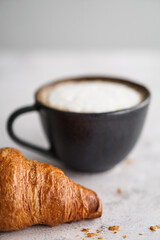 Cup of coffee and croissant