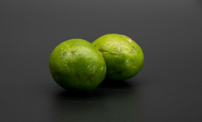 two hog plum fruits isolate on black background.