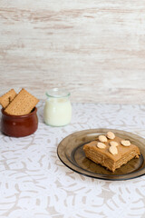 Sweet milk cake on white background with milk and cookies