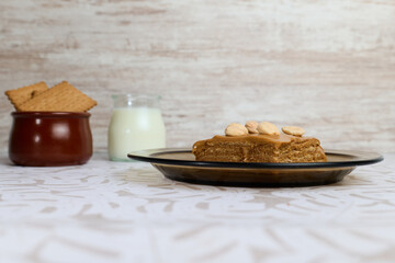 Sweet milk cake on white background with milk and cookies