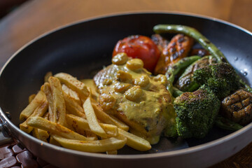 grilled chicken breast with fries and vegetables 