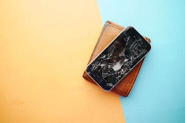Top view of broken smart phone on color background 