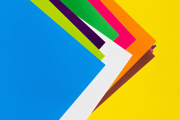 abstract geometric background with colored paper sheets.