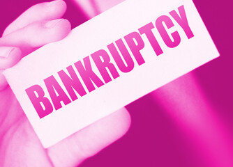 Bankruptcy on a card. Businessman holding a card with word Bankruptcy. Crisis business closing...