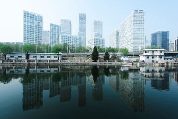 Fototapeta premium City buildings are reflected on the river