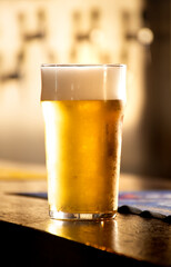 English pint of pale lager or chilled lager at pub counter