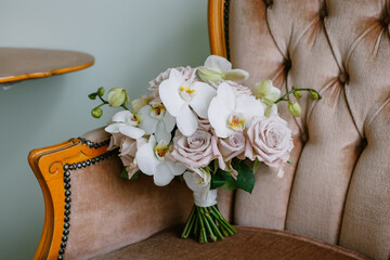 Beautiful wedding bouquet for the bride. Brown armchair on background